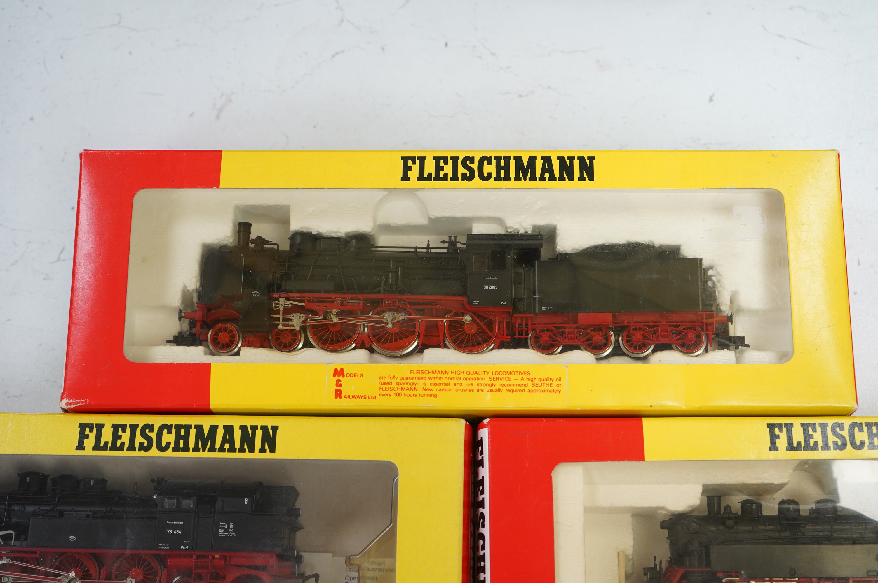 Three boxed HO gauge railway German outline locomotives; a 38 2609, 4-6-0, (4160), a 78 434, 4-6-4T, (4078), and an 064 389-0, 2-6-2T, (4064), all in red and black livery. Condition - good.